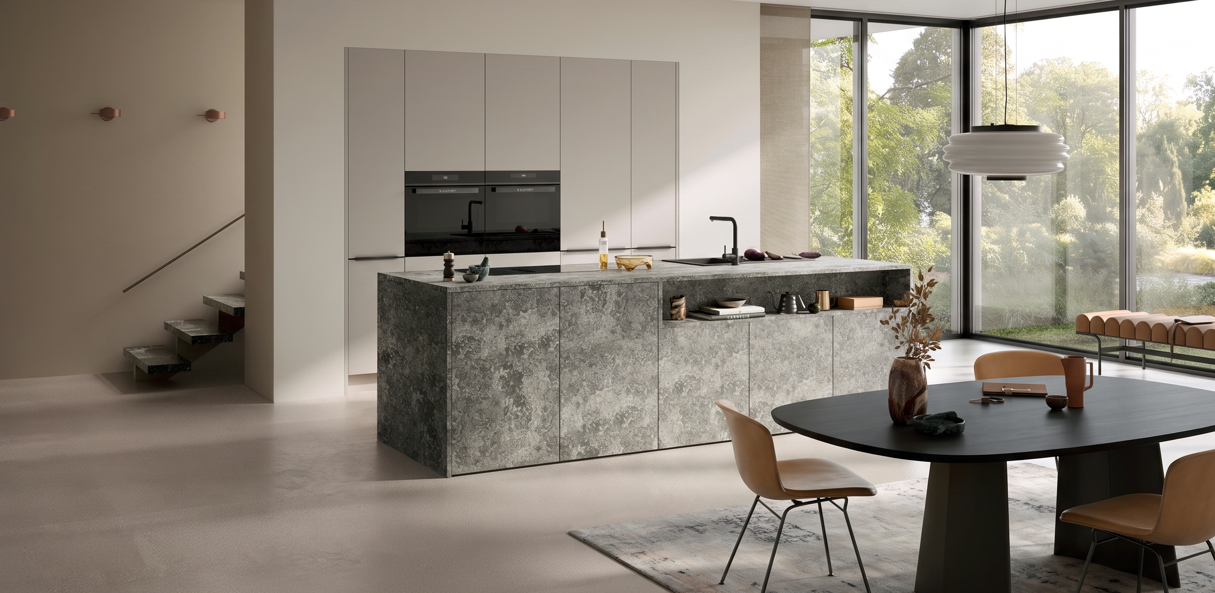 Kücheninsel in Anthrazit-Granitoptik vor einer Hochschrankwand in Steinbeige, Häcker concept130 ATRIUM