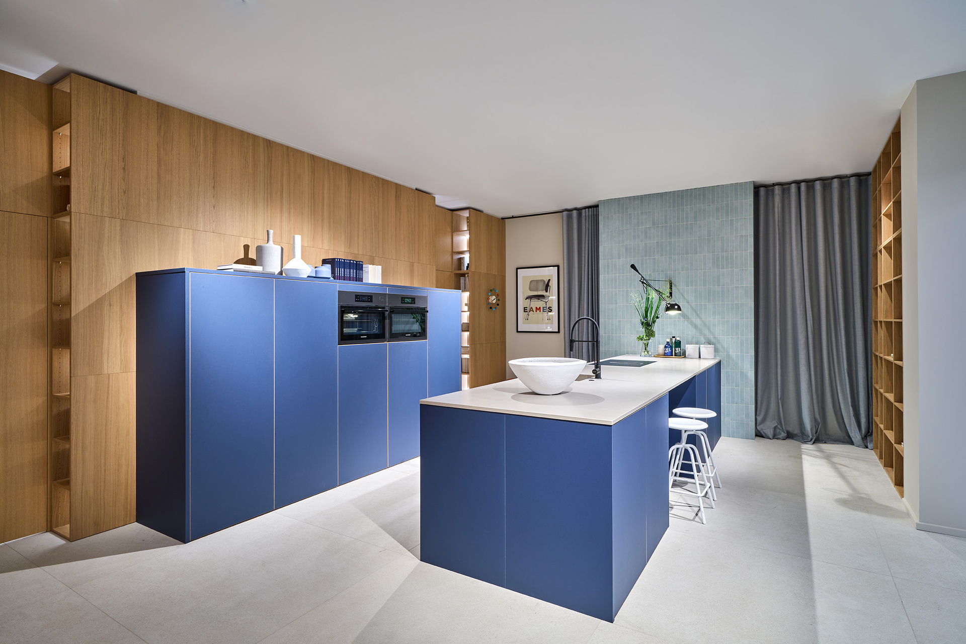 Overall view of a blue kitchen with wood