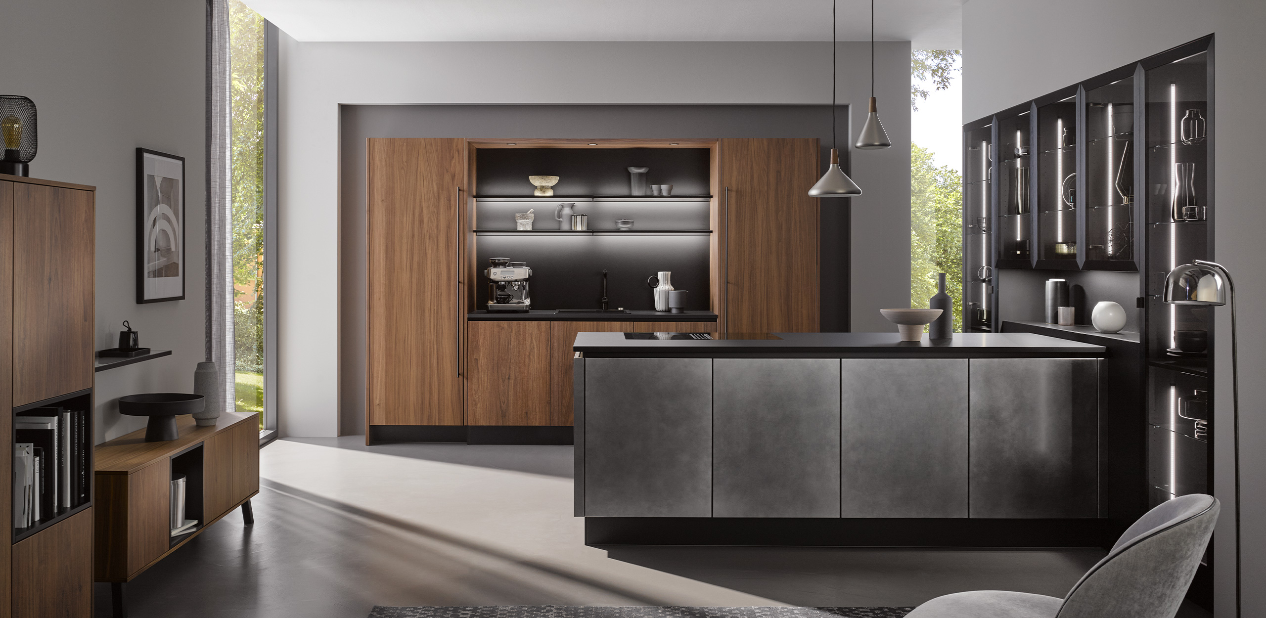 Bild der systemat AV 6082-GL Nussbaum-elegant mit Kücheninsel im Industriestahl-Look im Vordergrund 